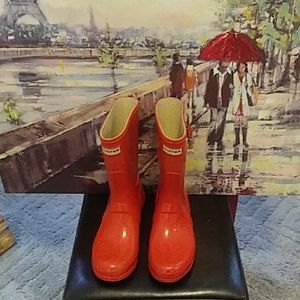 Orange three quarter rain boots by Hunter